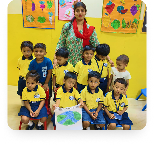 Adamas Kids students with their teacher holding a World Earth Day poster